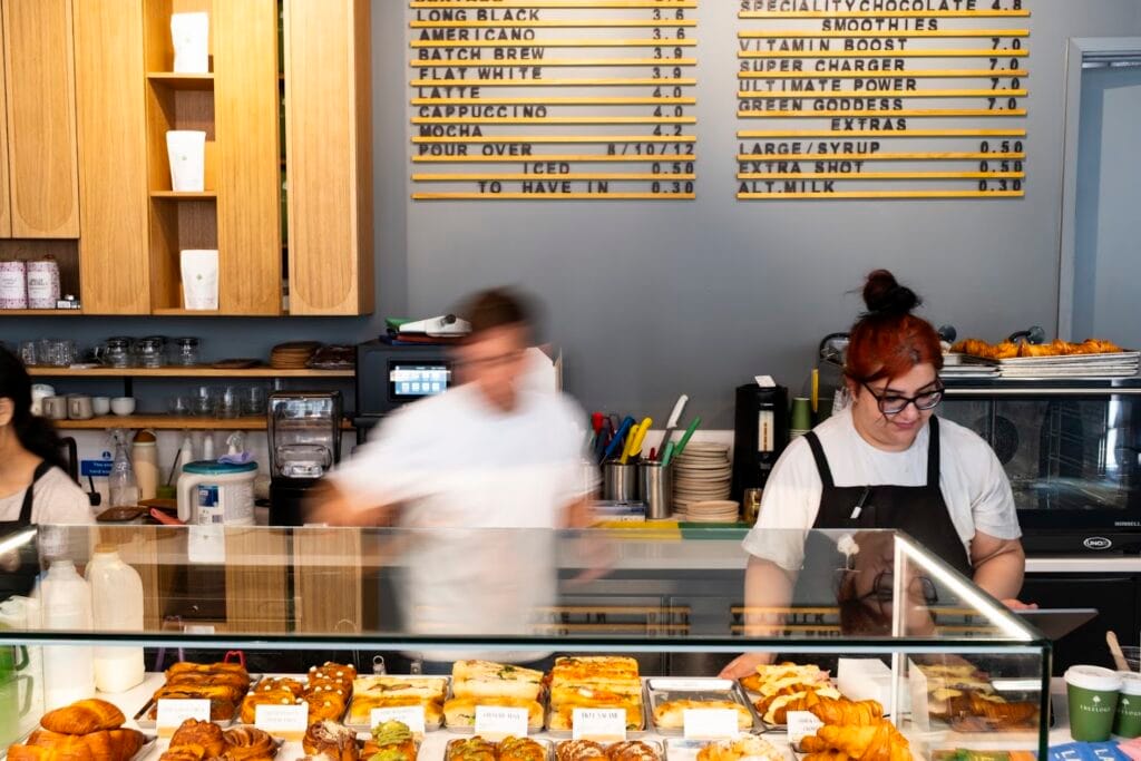 Baristas working behind the bar at a Treelogy venue
