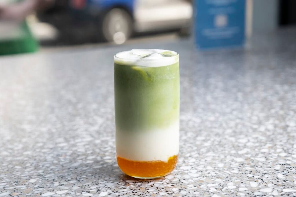 An iced matcha latte on a terrazzo counter