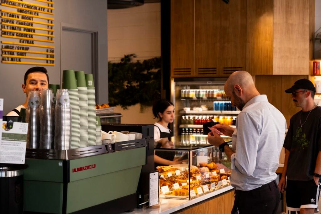 Customers queuing at the counter inside a Treelogy Coffee venue