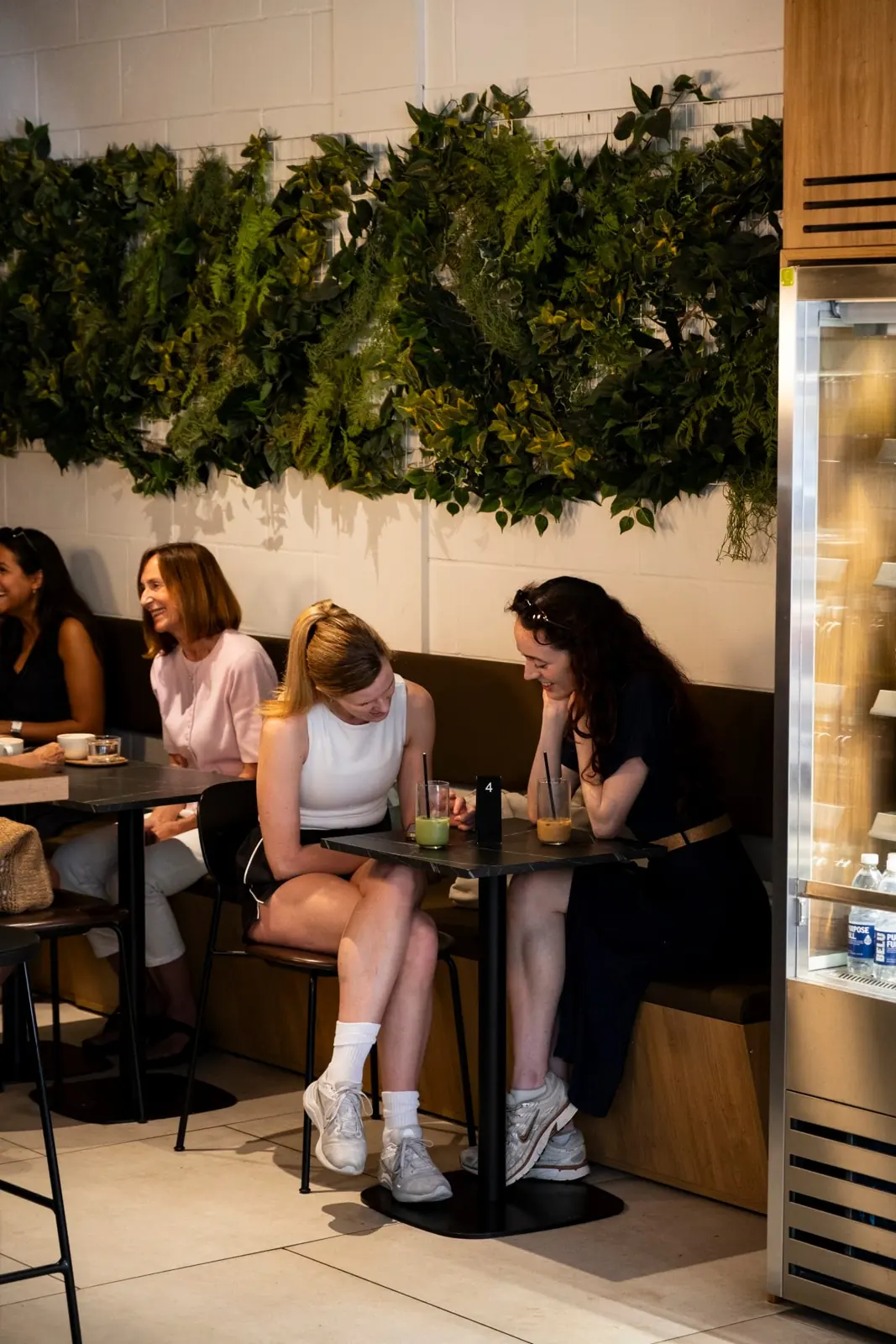 Friends chatting at a table in a coffee shop
