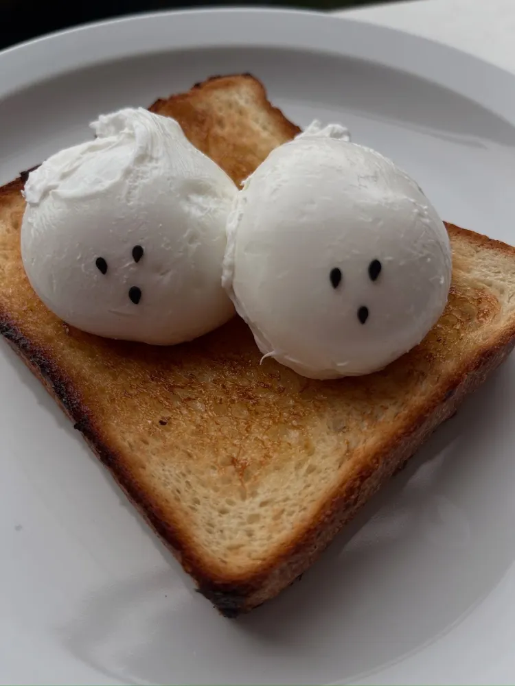 Two ghost-shaped buns on toast