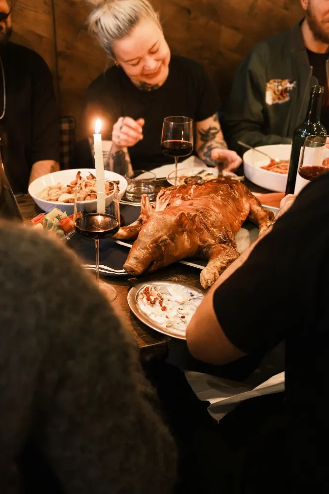 Guests around a candlelit dinner table