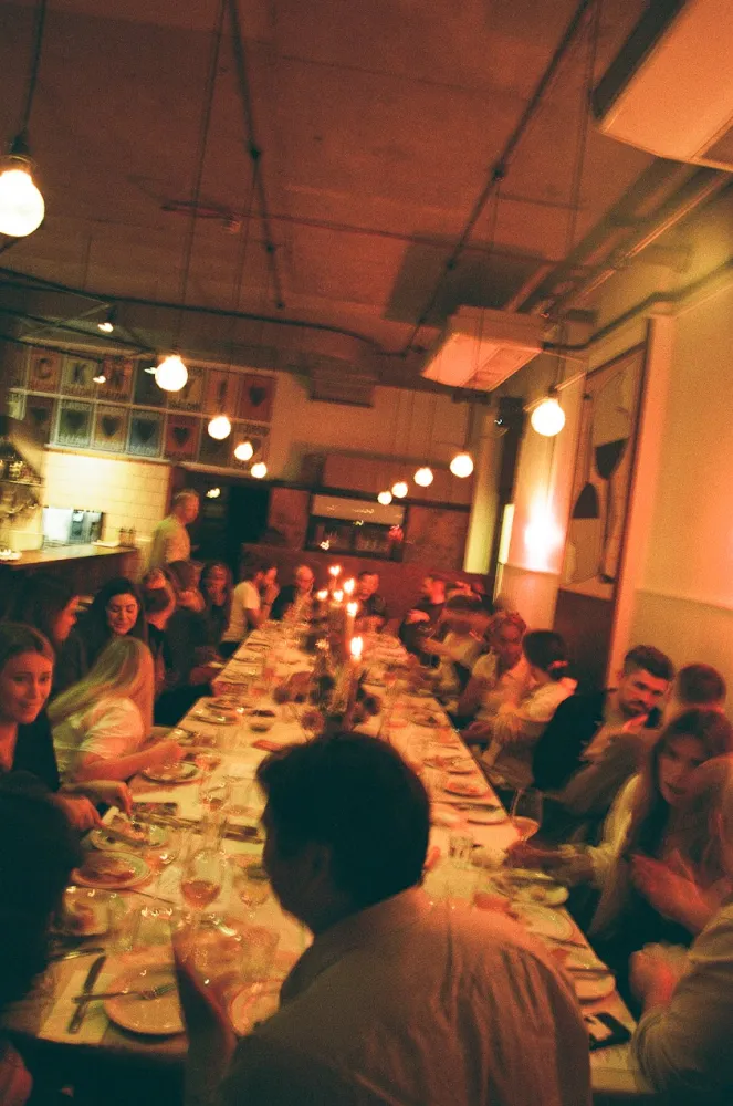 A long candlelit supper club table